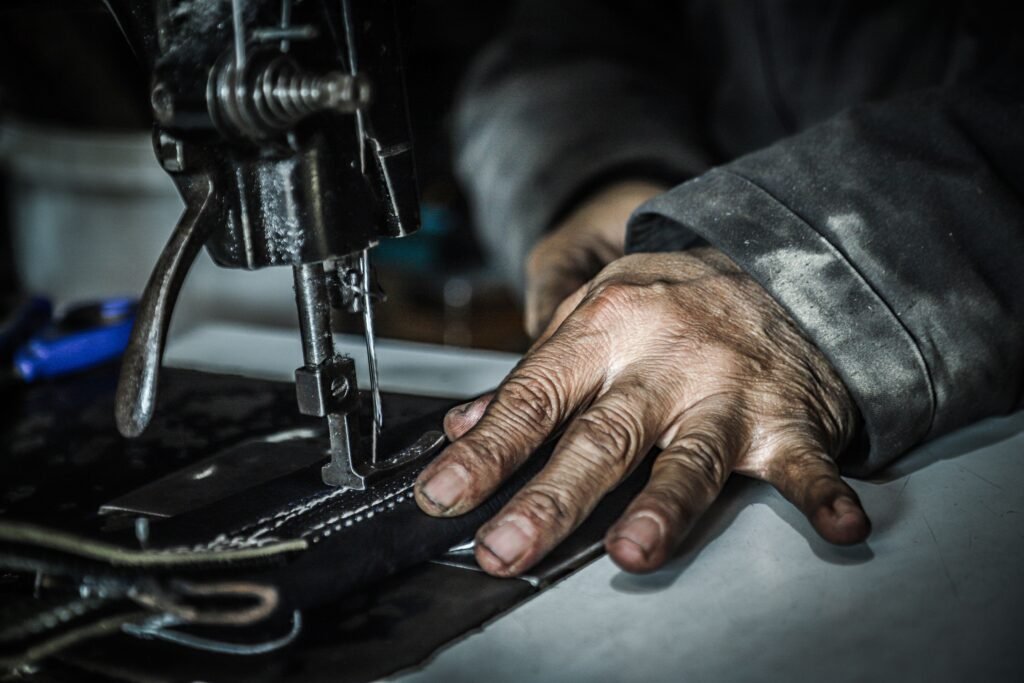 Hand stitching and machine stitching compared on a leather seam