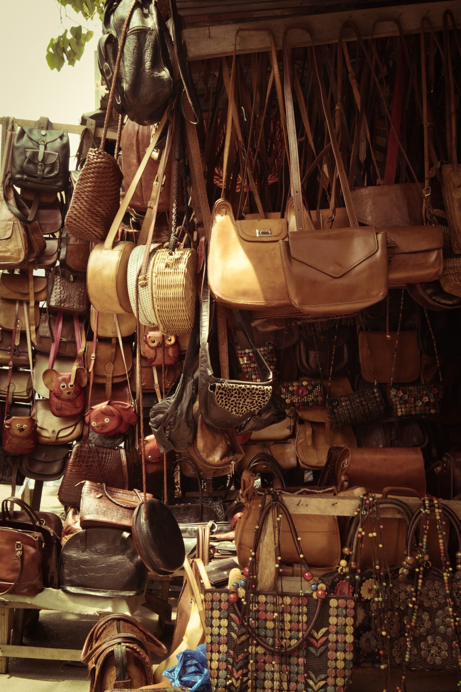 Handmade leather bags and goods hanging in a Moroccan souk